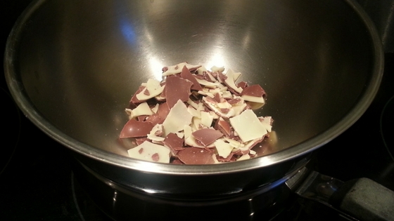 Easter chocolate broken up into small pieces, placed in a saucepan, ready for melting