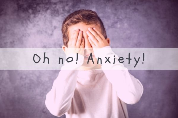 Young boy wearing a white shirt covering eyes with text overlay: "Oh no! Anxiety!"